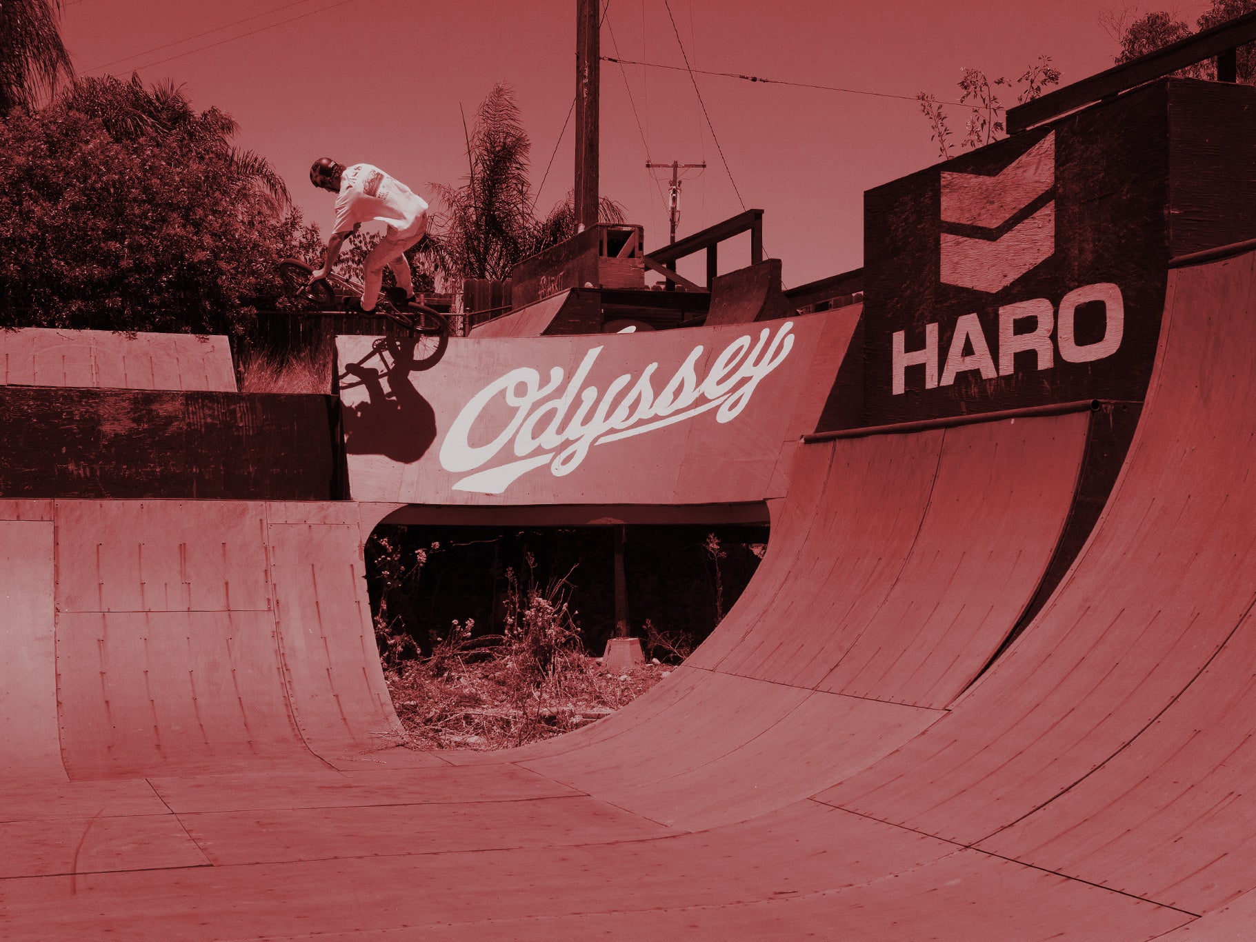 A sequence of images showing a bmx rider performing a trick, jumping off steps, captured in multiple stages.