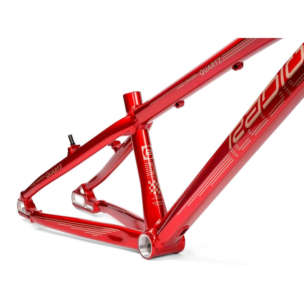 Close-up of the Radio Raceline Quartz 2025 Pro XL Cruiser Frame in metallic red aluminium with white graphics and "QUARTZ" branding, designed for BMX race bikes and compatible with a sliding dropout disc system.