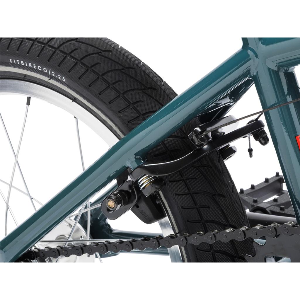 Close-up of the rear wheel on a Fit Bike Co Misfit 16 kids BMX, showcasing the tire, chain, and brake caliper mounted on its teal frame.
