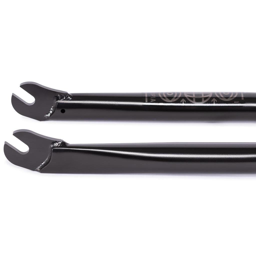 Close-up of two black Wethepeople Utopia Flatland Forks (10mm Offset) dropouts, parallel with welded edges and open slots for the axle—a sleek, lightweight BMX fork designed for flatland tricks.