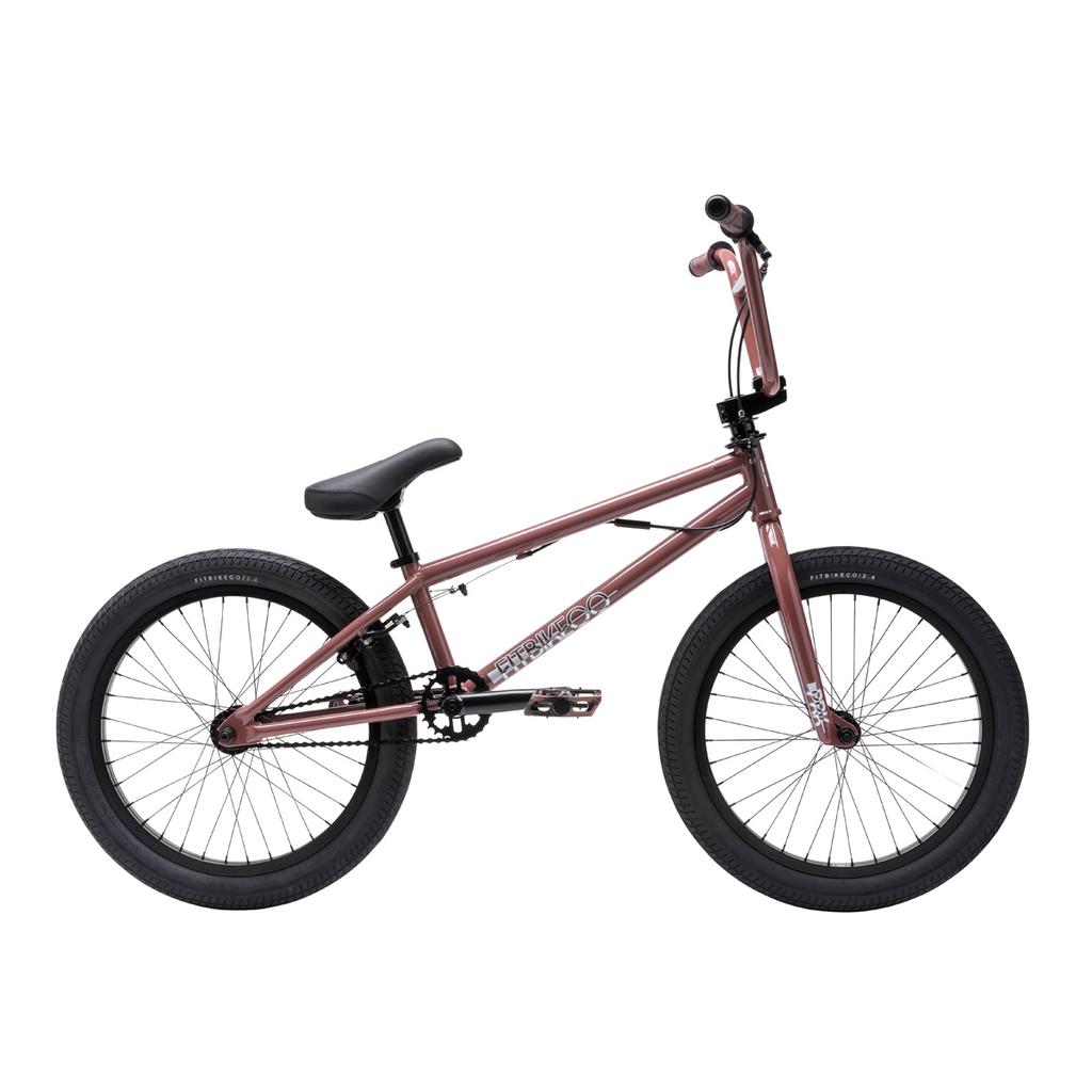 The Fit Bike Co PRK 20 Inch Bike is shown in rose gold with a short top tube, black tires, pedals, handlebars, and seat in side profile on a white background.