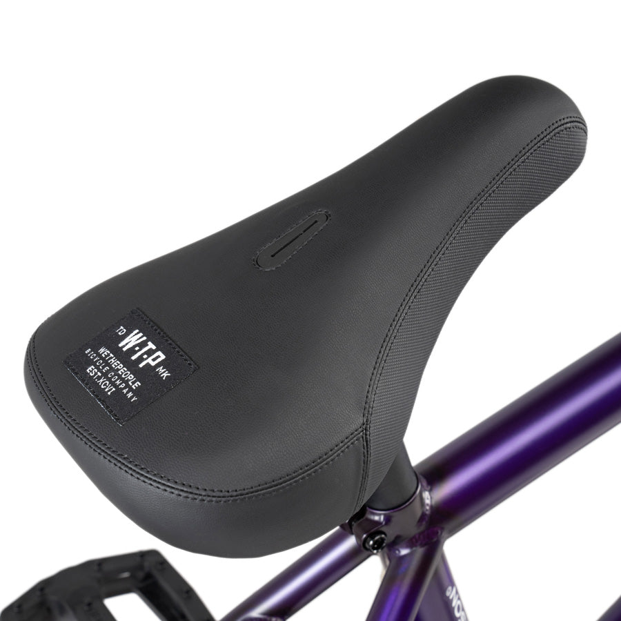 A close up of a Wethepeople Reason 20 inch BMX bike seat in purple.