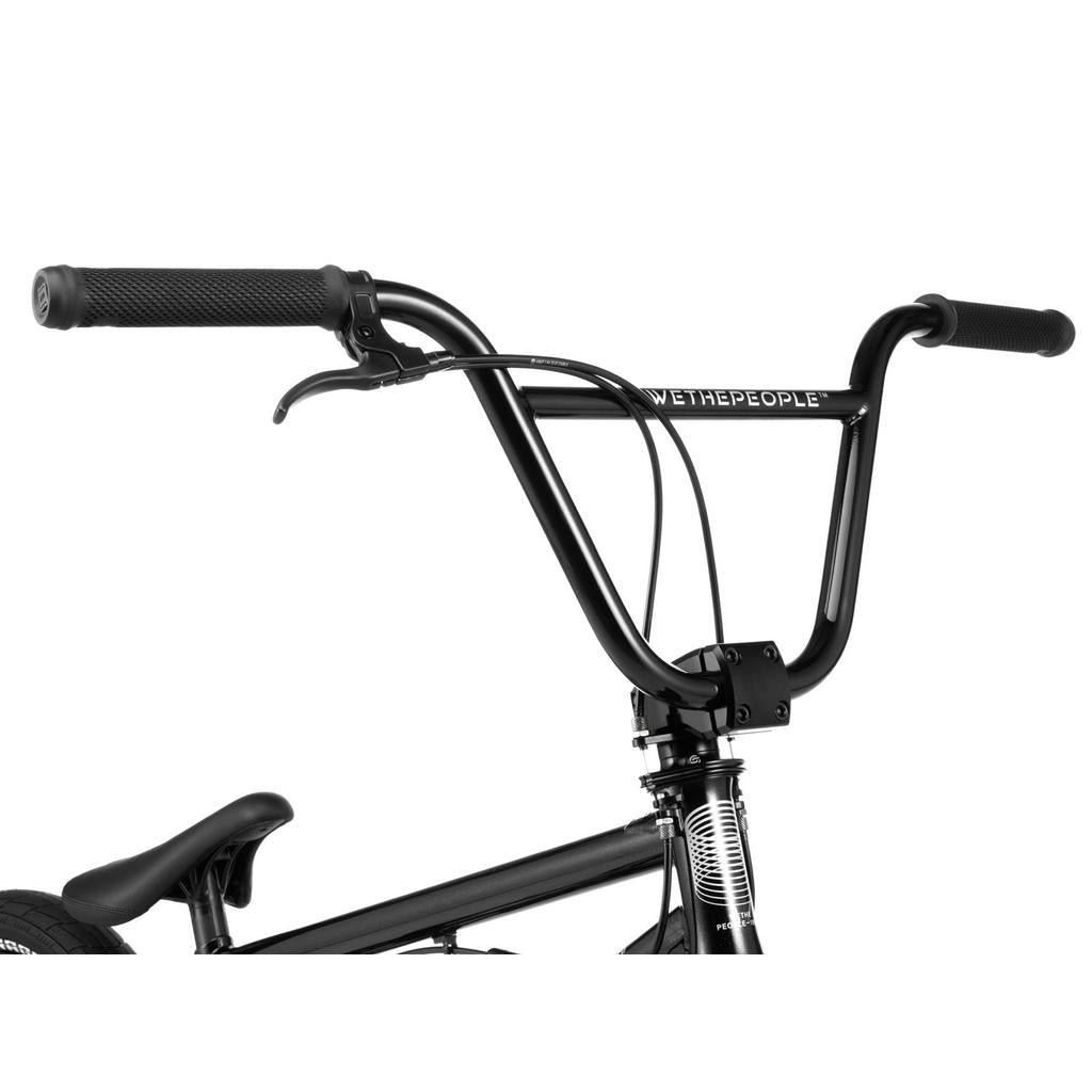 Close-up of the Wethepeople Versus 20 Inch Bike’s black handlebar and upper frame, featuring bold "WETHEPEOPLE" branding—ideal for skatepark BMX enthusiasts.