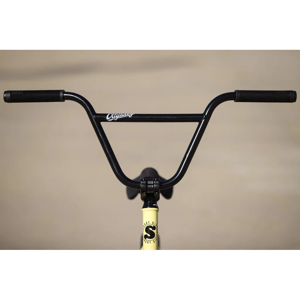Close-up of black BMX handlebars on a yellow Sunday Soundwave Special Bike (2025) frame, featuring premium Odyssey parts, set against a neutral background.