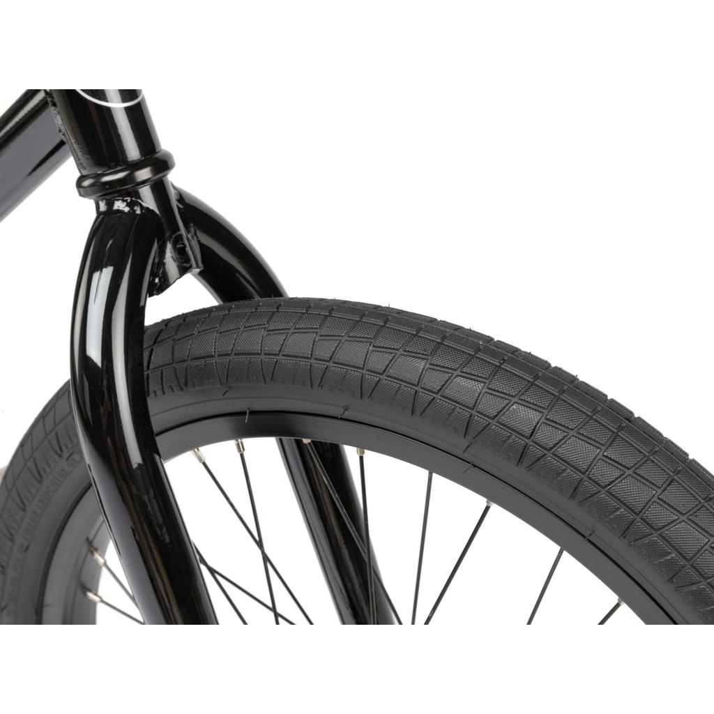 Close-up of the Radio Revo Pro 20 Inch Bike’s front wheel, showcasing the tire tread, black rim, and spokes against a white background.