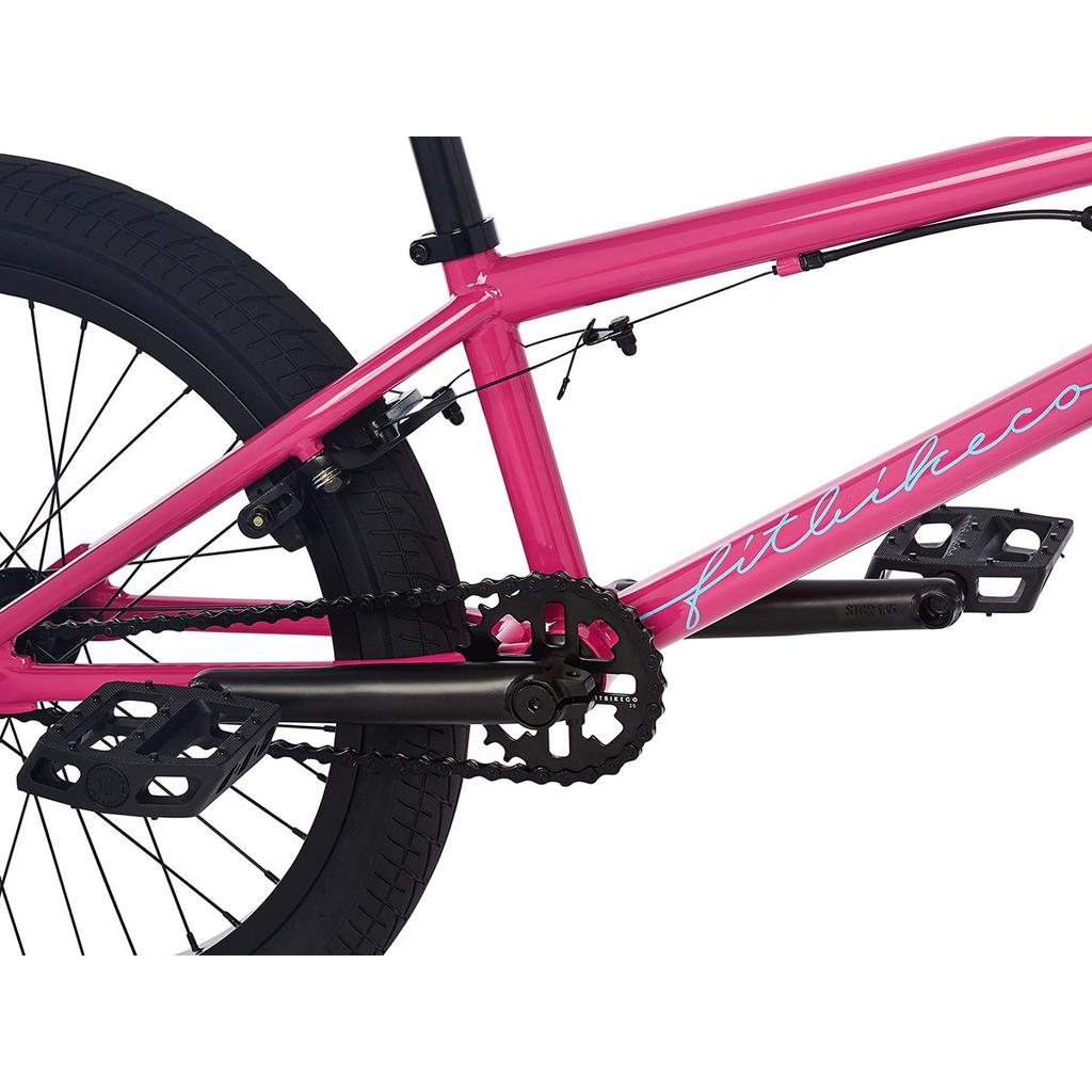 Close-up view of the Fit Prk 20 Inch Bike (2023) in pink, showing its frame, rear wheel, pedals, chain, and sealed bearing crankset.