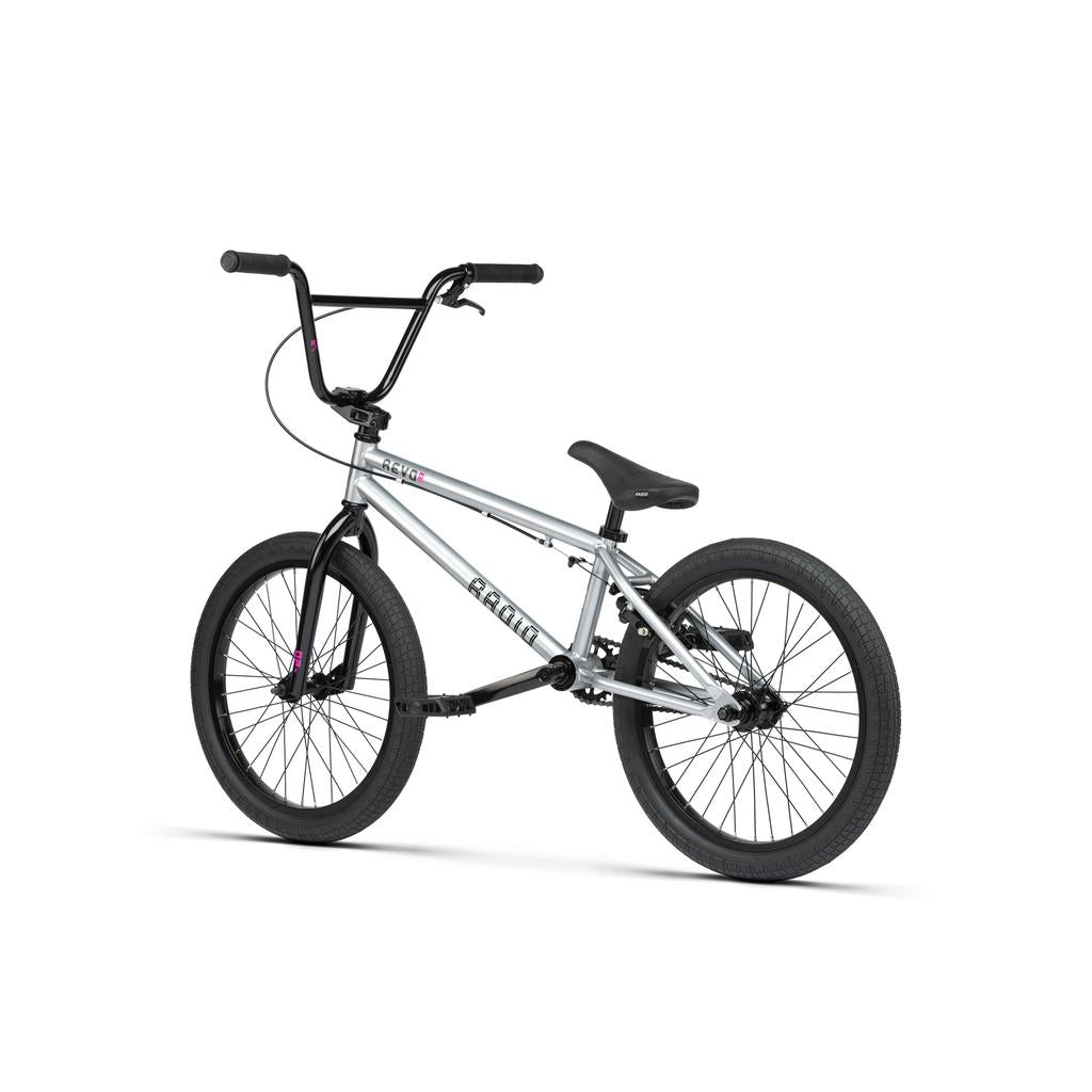 The Radio Revo Pro 20 Inch Bike, shown from the side on a white background, has a silver frame with black handlebars, seat, and tires. It features Radio Rookie Three Piece Cranks for enhanced performance.