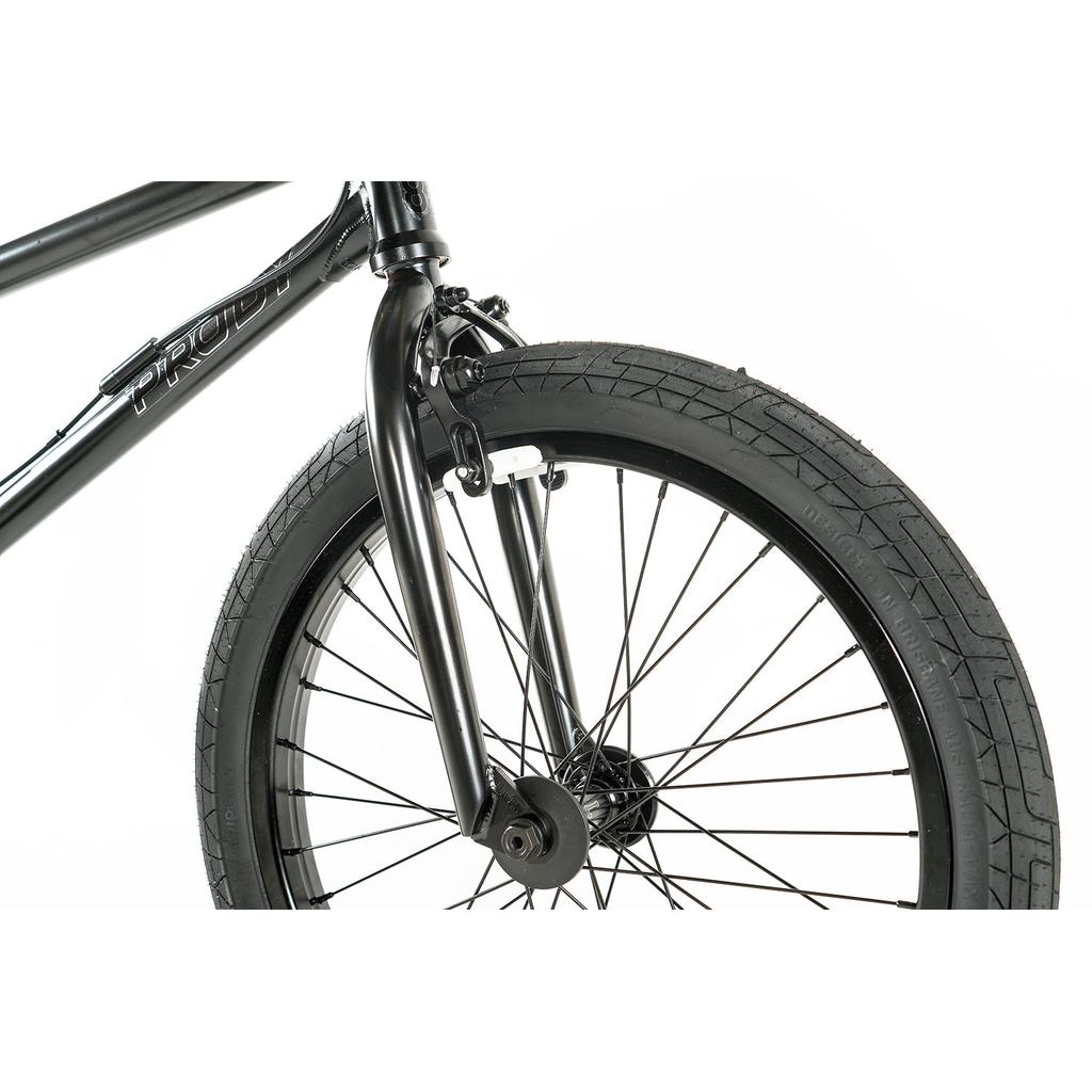 Close-up of the Colony Prody Pro 20 Inch Bike’s black front wheel, highlighting the tire, spokes, fork, and mounted brake against a white background.