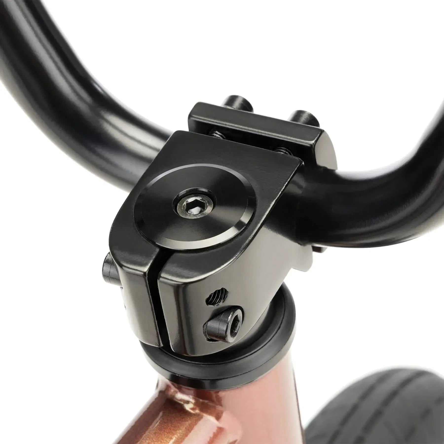 Close-up view of the Kink Roaster 12 Inch Bike (2026) handlebar stem attached to the frame, showing bolts and part of the front wheel.
