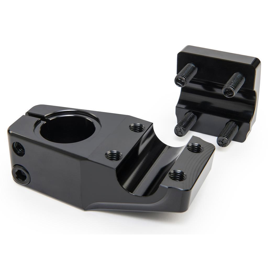 The Eclat Dune Stem is a black 6061-T6 alloy metal clamp with a detachable plate and four screws, designed to securely hold cylindrical components.