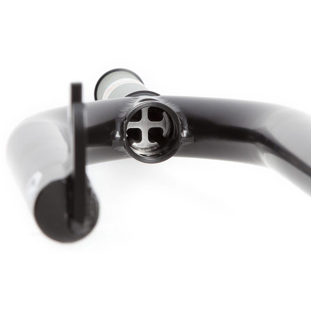 Close-up of a black bike handlebar with internal cable routing, paired seamlessly with S&M Pitchfork XLT 22inch Forks at the center.