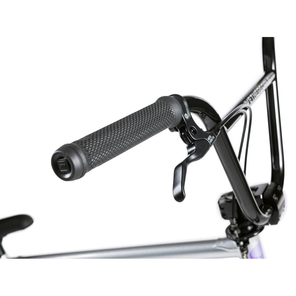 Close-up of a black BMX handlebar with textured rubber grip and brake lever, attached to the silver Wethepeople Versus 20 Inch Bike.