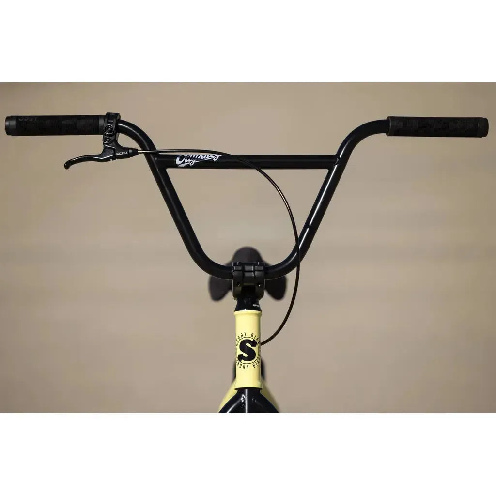 Close-up of the Sunday Soundwave Special Bike (2025) showing black handlebars, brake lever, Odyssey parts, yellow frame, and headset cap/logo. Protected by the 41-Thermal Lifetime Warranty for lasting durability.