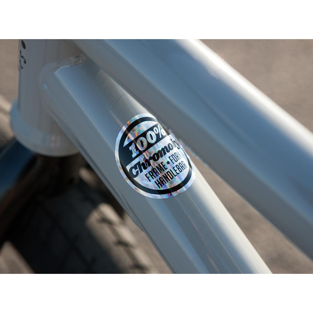 Close-up of the Sunday EX Erik Elstran 20 Inch Bike in silver with a "100% chromoly frame, fork, handlebar" sticker, emphasizing its durability and premium build.