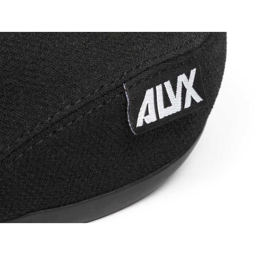 Close-up of a black fabric shoe with a sewn black label reading "ALYX" on the side, inspired by the sleek BSD Alvx Eject Pivotal Seat, an Alex Donnachie signature BMX part.