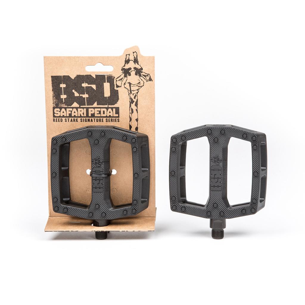 Two BSD Safari PC Pedals are shown: one attached to its branded packaging and the other standing separately. These BMX pedals feature textured surfaces for grip and are made from durable nylon fibreglass.