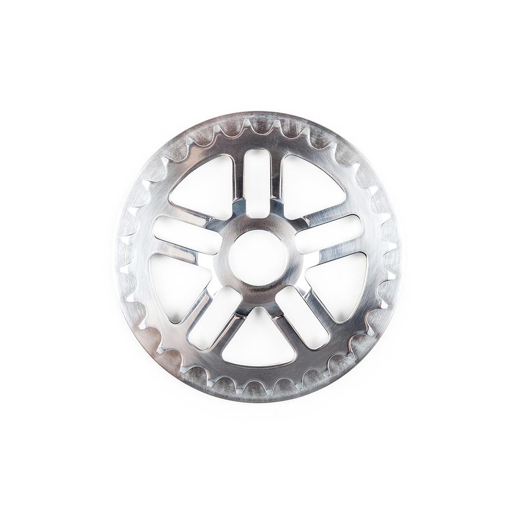 A close-up of the BSD Guard Sprocket, featuring evenly spaced teeth and five rectangular cutouts, crafted from durable 7075-T6 alloy, photographed on a white background.