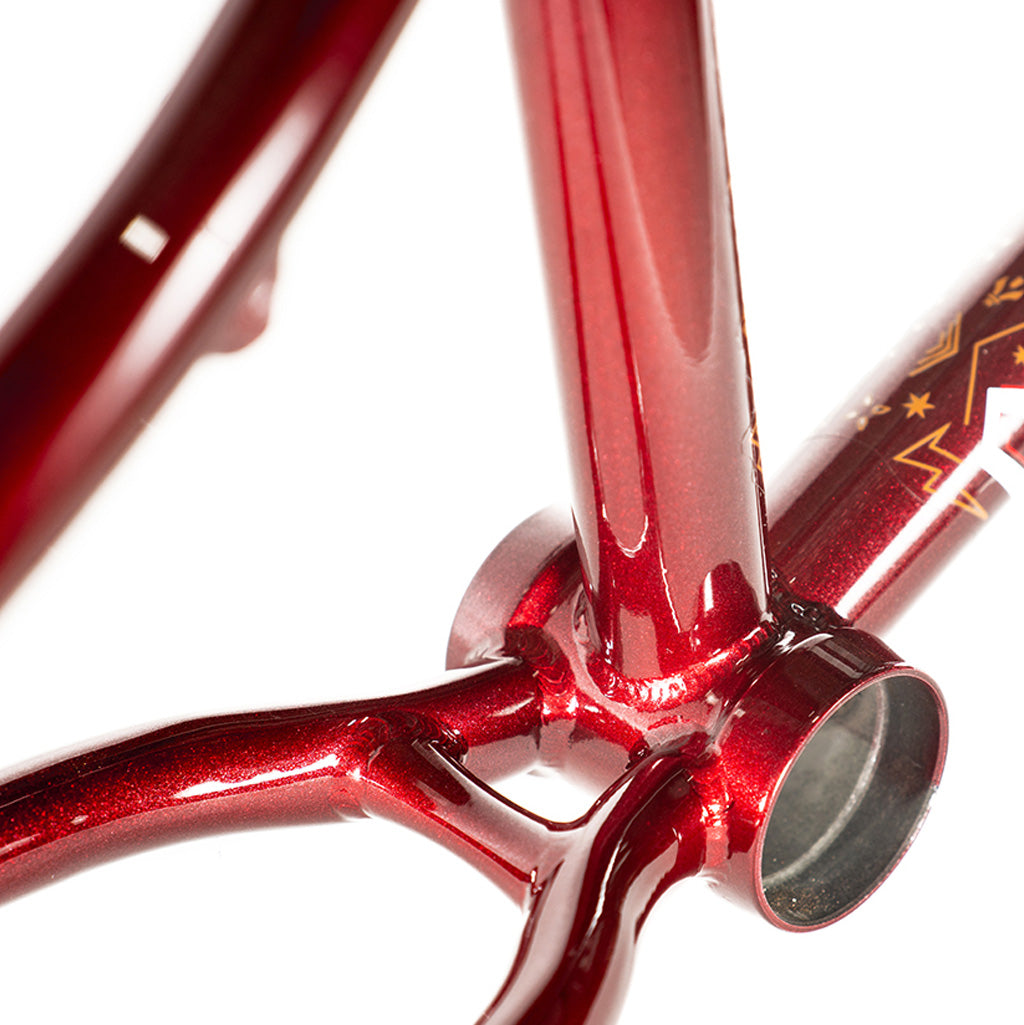 A close up of the Colony Rico 'Lite' Frame, in vibrant red. The Colony Rico 'Lite' Frame is displayed in a close-up shot, showcasing its vibrant red color.