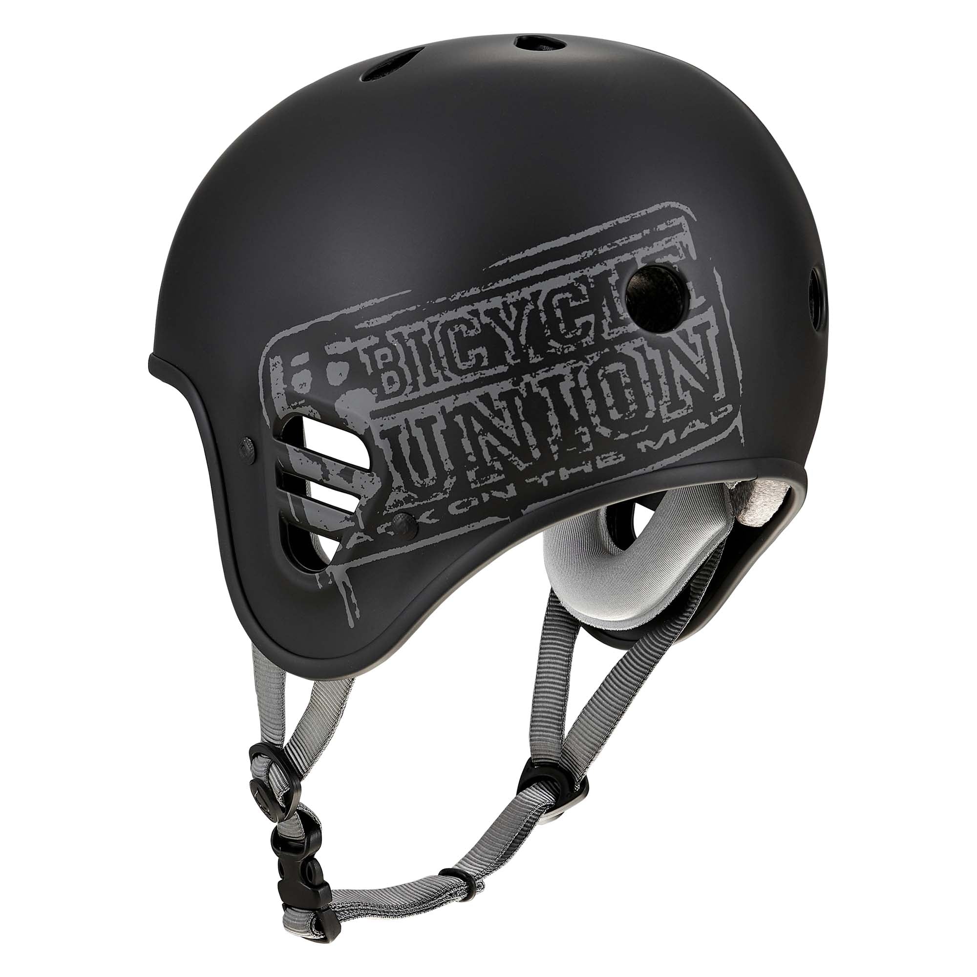 The Protec Full Cut Helmet / Bicycle Union Signature features a matte black finish with gray straps and a distinctive "Bicycle Union" graphic on the side. Inspired by the iconic Pro-Tec Full Cut design, it includes a high-impact ABS shell, multiple ventilation holes, and a secure chin strap buckle for optimal safety and comfort.