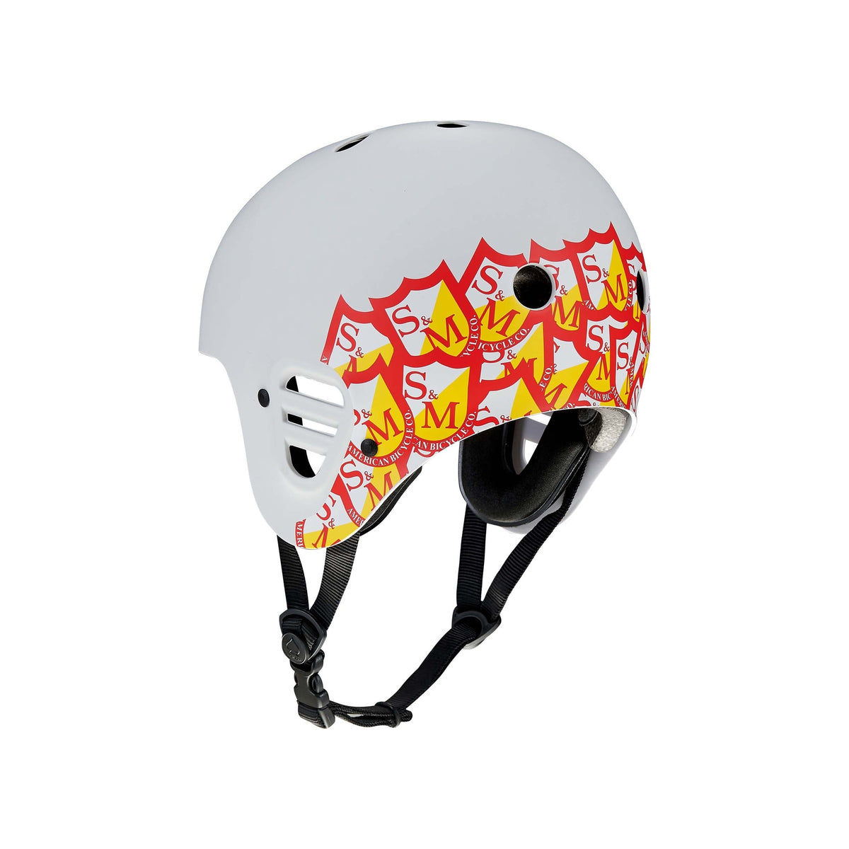 Light grey Protec Full Cut helmet featuring the S&M signature red and yellow logo pattern on the side, black straps, ventilation holes, and high-impact protection—perfect for action sports.