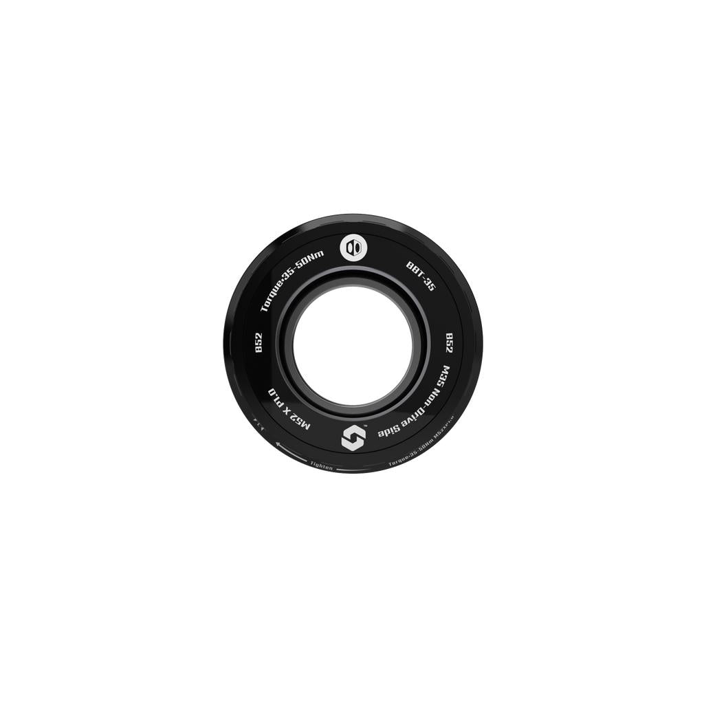 A black circular BMX hub guard with white text and branding, made to complement the Box ONE Bottom Bracket B52 35mm for enhanced bike power transfer.