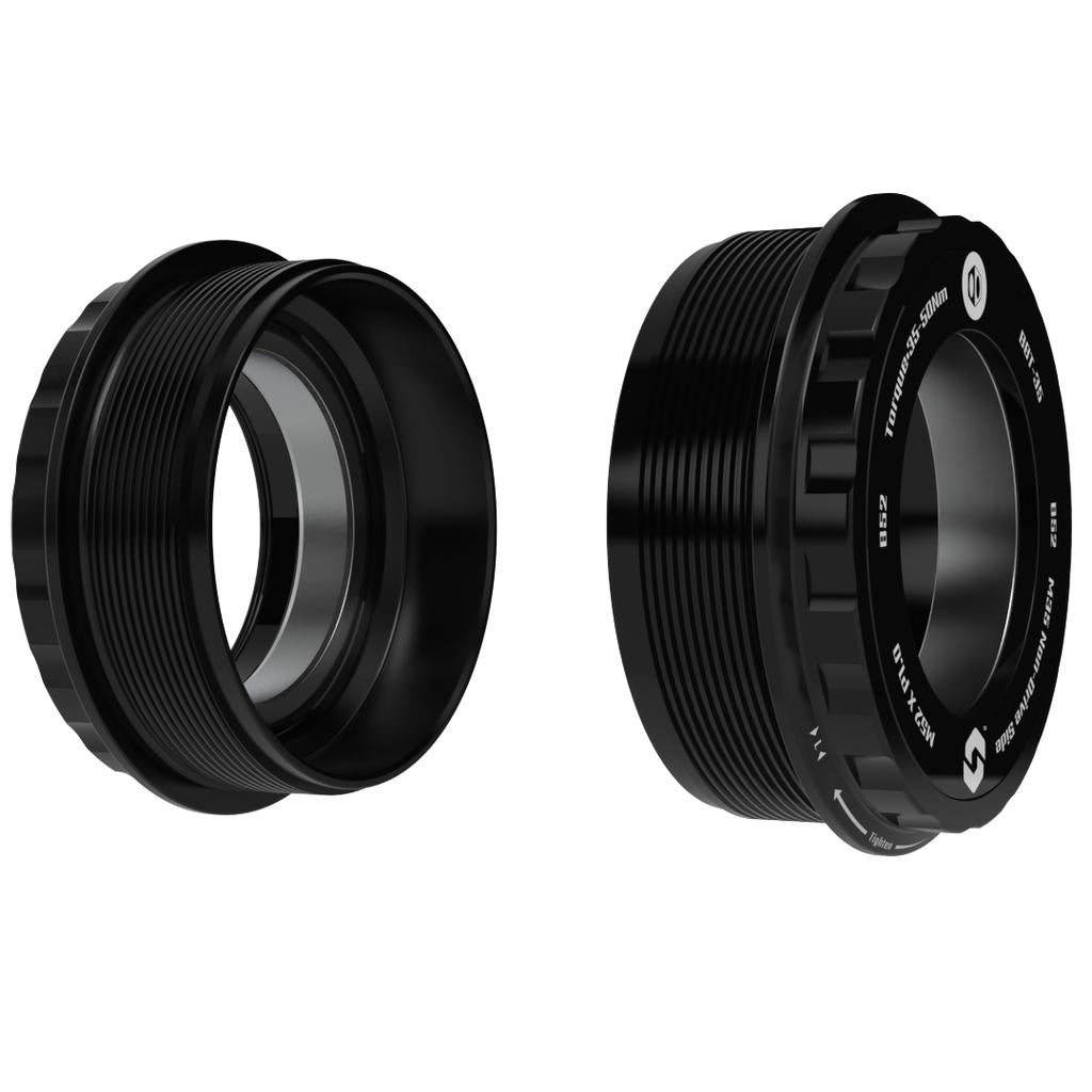 Two black, cylindrical metal components with threaded exteriors—Box ONE Bottom Bracket B52 35mm—are shown from different angles on a white background, designed for enhanced bike power transfer using Oversized Technology.