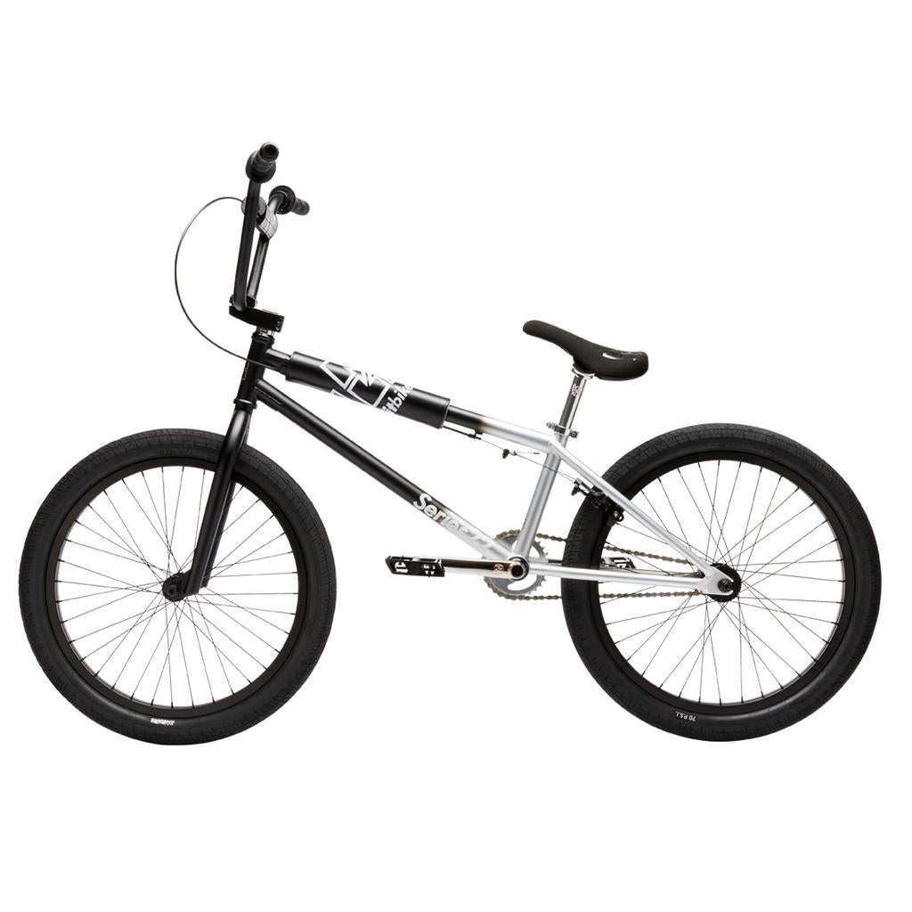 Side view of the Fit Bike Co Series 22 Inch Bike in black and silver, featuring thick tires, a straight top tube, and a padded seat, displayed against a white background.