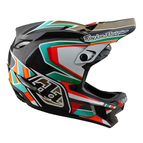 The TLD 25.1 D4 Carbon Helmet (MIPS) in Frames Black/Gold is a vibrant full-face motocross helmet featuring geometric patterns, "Troy Lee Designs" branding on the visor and chin area, and MIPS Protection for enhanced safety.
