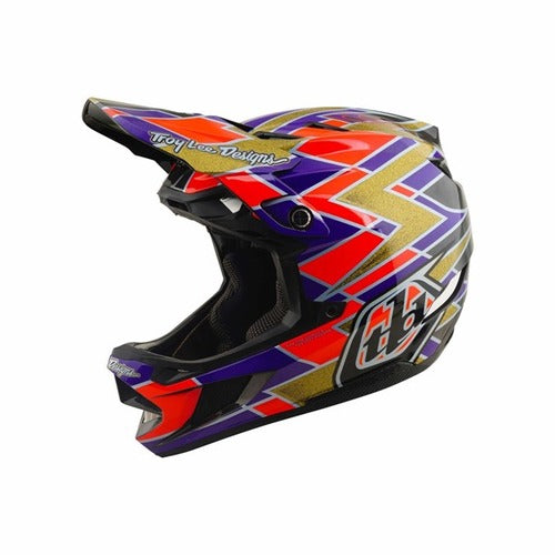 The TLD 26.2 D4 Carbon Full Face Helmet / MIPS Flush Violet is a full-face mountain bike helmet featuring a vibrant geometric design in purple, red, gold, and black, with the “Troy Lee Designs” logo and number 88 on the side. Enhanced with Mips protection for advanced safety, this striking downhill helmet offers standout style and performance.