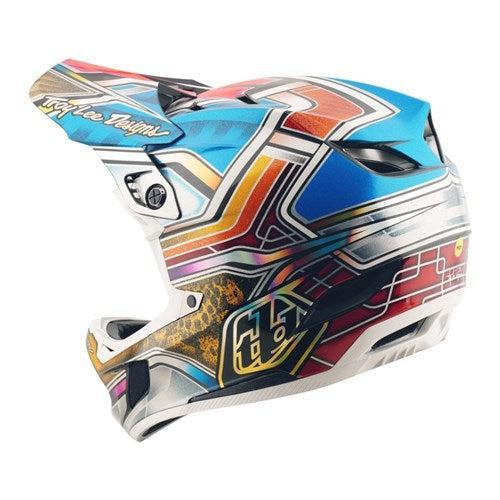 The TLD 25.2 D4 Carbon Helmet MIPS Lowrider Blue is a full-face mountain bike helmet with bold abstract geometric patterns in blue, red, yellow, and white, offering advanced Mips protection.