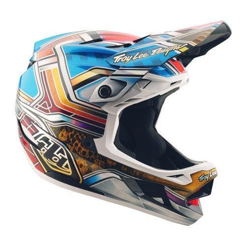 The TLD 25.2 D4 Carbon Helmet MIPS Lowrider Blue features bold geometric patterns, Troy Lee Designs branding, and advanced Mips protection—ideal for motocross or mountain biking adventures.