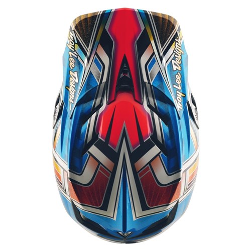 The TLD 25.2 D4 Carbon Helmet MIPS Lowrider Blue is a full-face mountain biking helmet with Mips protection and a geometric multicolored design in red, blue, black, gold, and white plus "Troy Lee Designs" text on both sides.