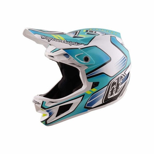 The TLD 26.1 D4 AS Composite Helmet / Crest Real Teal is a full-face motocross helmet in teal, white, and black with the Troy Lee Designs logo, featuring advanced Mips protection for added safety.