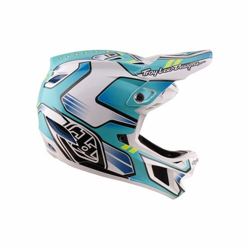 The TLD 26.1 D4 AS Composite Helmet / Crest Real Teal is a BMX helmet in white, blue, and teal with geometric patterns, "Troy Lee Designs" on the visor, and advanced Mips protection for enhanced safety.