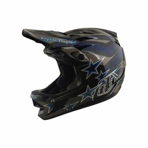 The TLD 26.2 D4 Composite Helmet / MIPS Burst Grey is a black and blue full-face helmet with star patterns and the “Troy Lee Designs” logo on the visor, shown in a side profile view. Inspired by motocross, this mountain biking helmet features advanced Mips protection for enhanced safety.