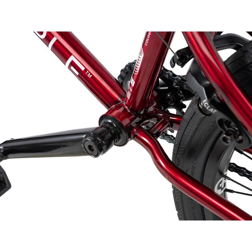 Close-up of the Wethepeople Versus 20 Inch Bike frame showcasing the bottom bracket, crank arm, chainring, chain, and rear tire—ideal for skatepark BMX enthusiasts.