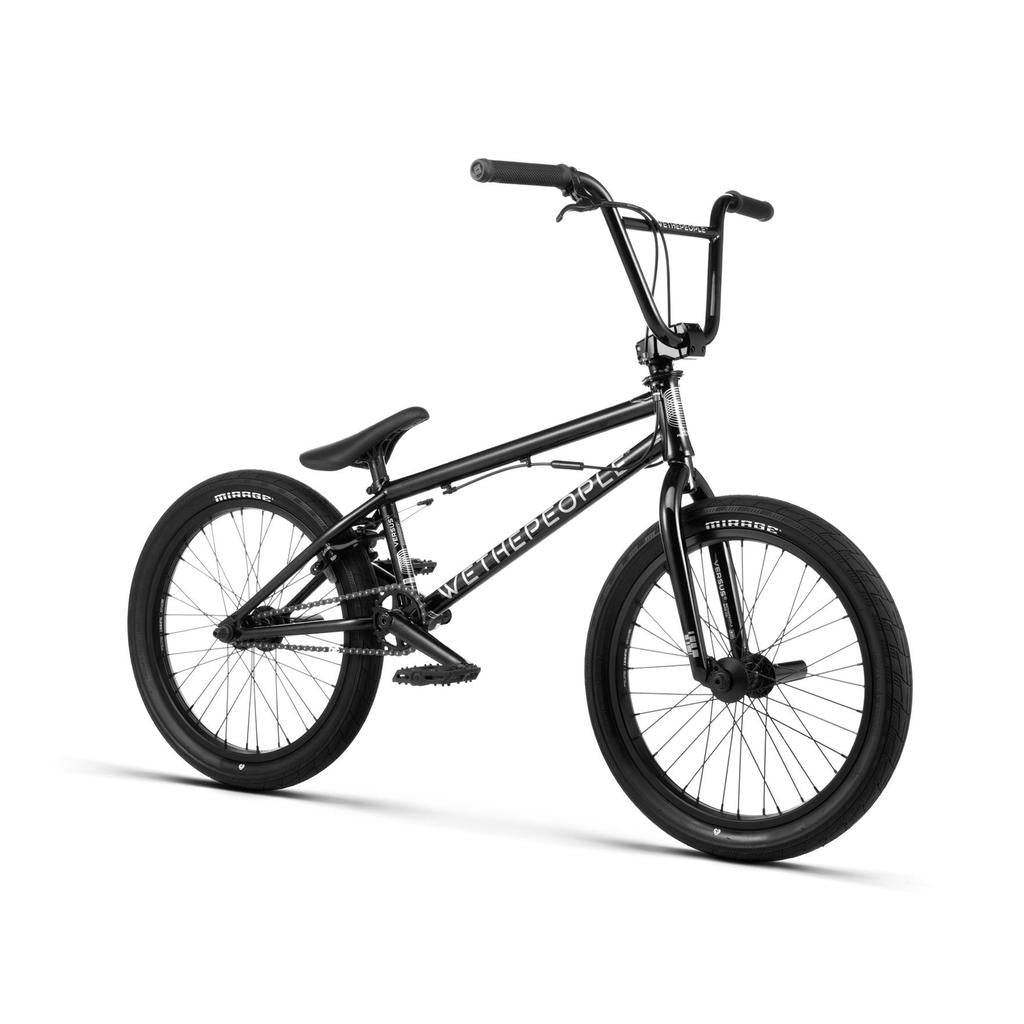 The Wethepeople Versus 20 Inch Bike is a black BMX skatepark bike with thick tires, padded seat, and "WE THE PEOPLE" on the frame, shown against a white background.