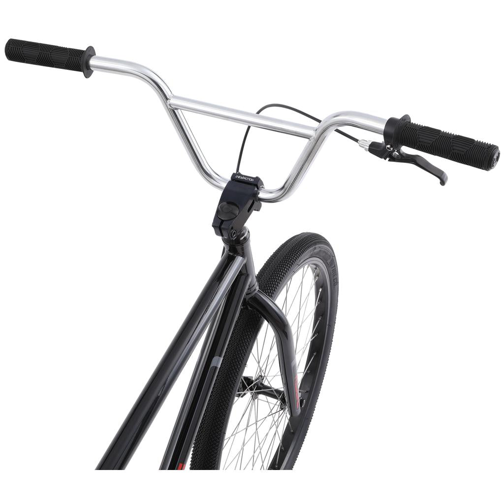 Close-up of the Redline PL 26 Inch Bike’s front section, highlighting its handlebars, brake lever, fork, and tire against a white background—showcasing its iconic design and durable chromoly steel frame.