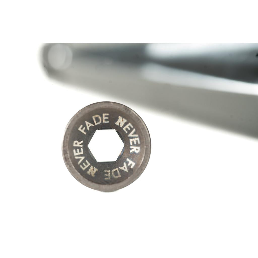 A close-up of a hexagonal metal bolt head engraved with "NEVER FADE" twice, designed for use with 22mm chromoly cranks such as the Cult Hawk V2 Cranks, shown against a white background.