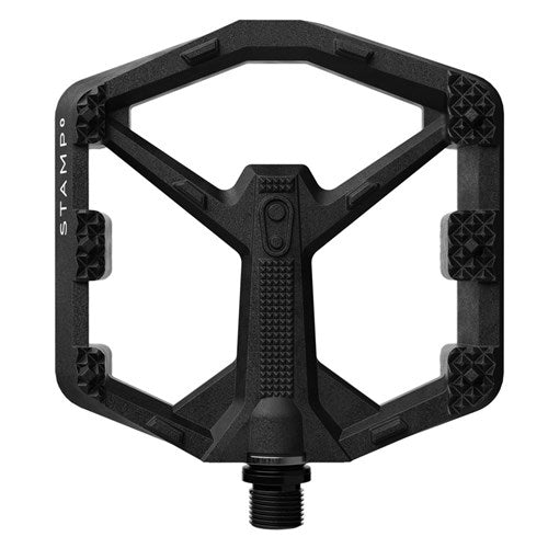 The Crank Brothers Stamp 0 Pedals (Small) feature a black composite body, textured grip areas for enhanced traction, "STAMP" marking on the left side, and a durable metal spindle at the bottom.