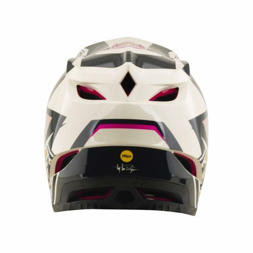 The TLD D4 Polyacrylite Helmet in Turbo Acid/Fuchsia is displayed from the back, showcasing its white and black color scheme with pink accents, multiple air vents for ventilation, the MIPS brain protection logo, and a distinctive signature graphic at the lower center—perfect for mountain biking enthusiasts who prioritize both style and safety.