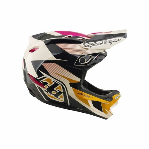 The TLD D4 Polyacrylite Helmet in the Turbo Acid/Fuchsia colorway features a bold black, white, pink, and yellow geometric design with Mips brain protection for enhanced safety, plus the iconic Troy Lee Designs logo on the visor and chin guard—making it a top choice for mountain biking adventures.