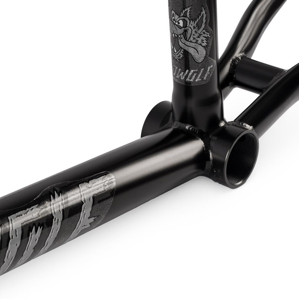 Close-up of a black Subrosa Speedwolf V2 Race Frame, showing silver wolf graphics and visible welds near the bottom bracket.