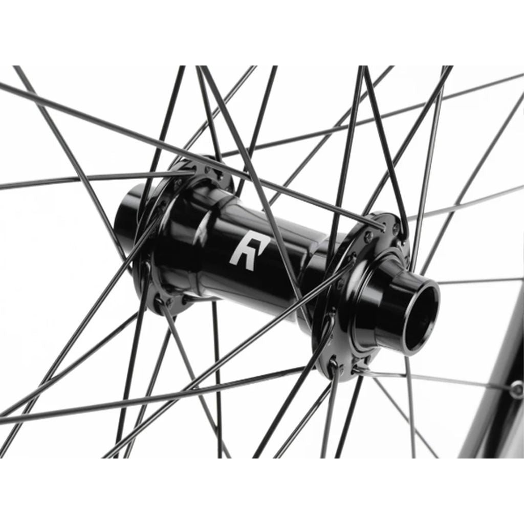 Close-up of a black Radio Orbiter/Sonar 26 Inch Front Wheel bicycle wheel hub and spokes, with a visible logo on the hub, against a white background.