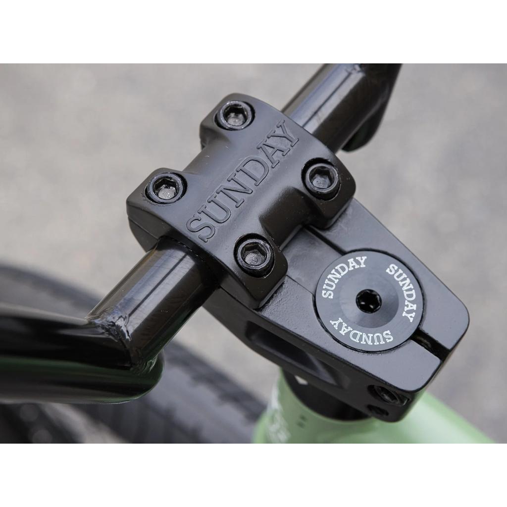 Close-up of the Sunday Forecaster 20 Inch Bike (2025) / Brett Silva, showing black pro-level BMX stem and handlebars with "SUNDAY" engraved and printed.