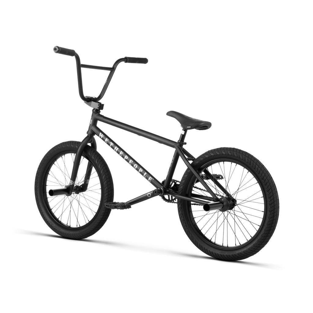 The Wethepeople Revolver 20 Inch Bike in black is displayed on a white background, featuring thick tires, a padded seat, high handlebars, and quality aftermarket parts.