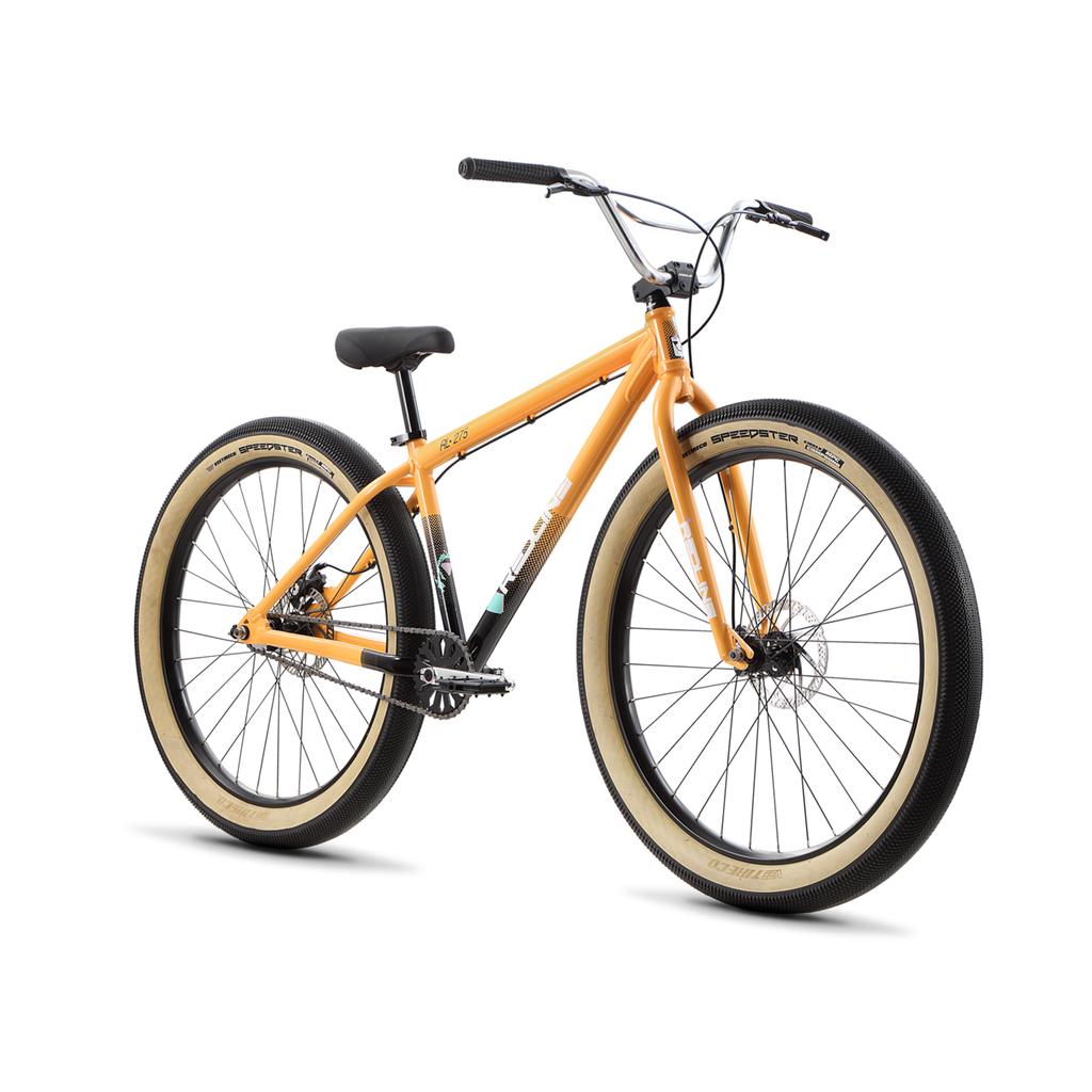 The Redline RL 275 27.5 Inch Bike is a retro BMX cruiser featuring thick, cream-colored fat tires and black rims, displayed on a white background.