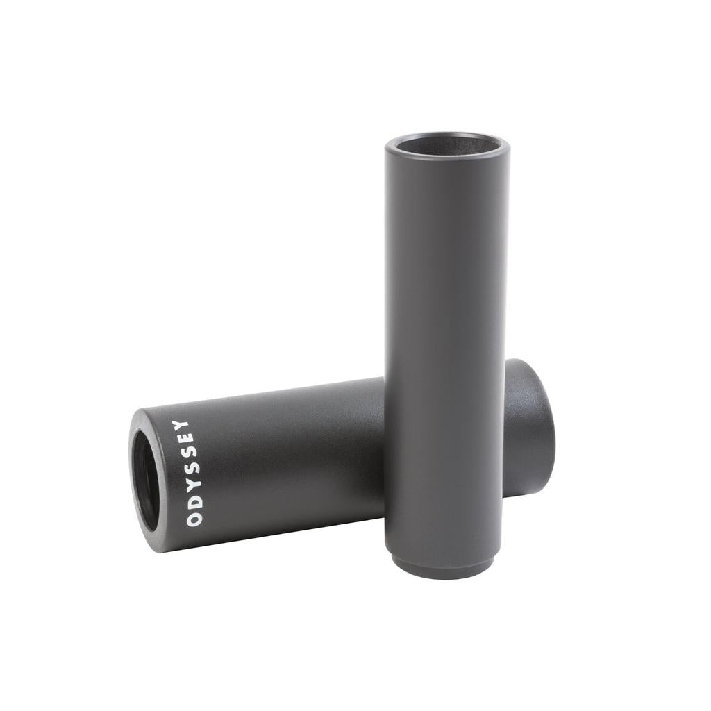 An Odyssey Joystick PC Peg in matte black plastic with a lightweight aluminum core stands upright, while another lies horizontally, both displaying "ODYSSEY" in white text.