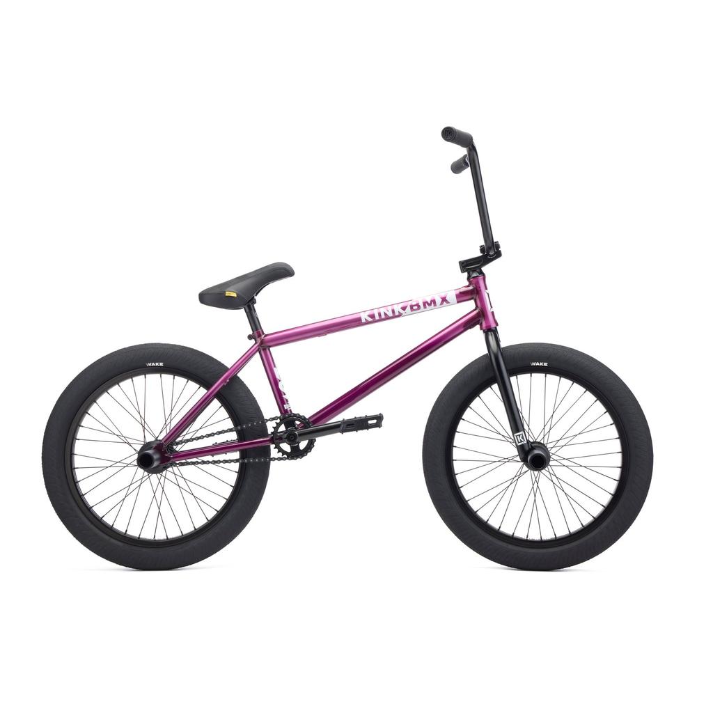 The Kink Downside 20 Inch Bike (2027) is shown in side view, featuring a purple chromoly frame with black handlebars, seat, pedals, and tires against a white background.