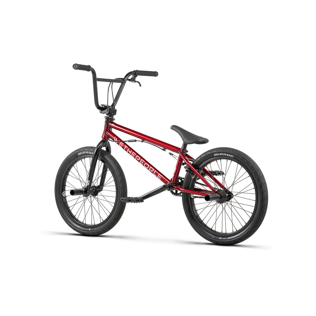 The Wethepeople Versus 20 Inch Bike in red features black handlebars, seat, and tires, shown from the side against a white background—ideal as a versatile skatepark bike.